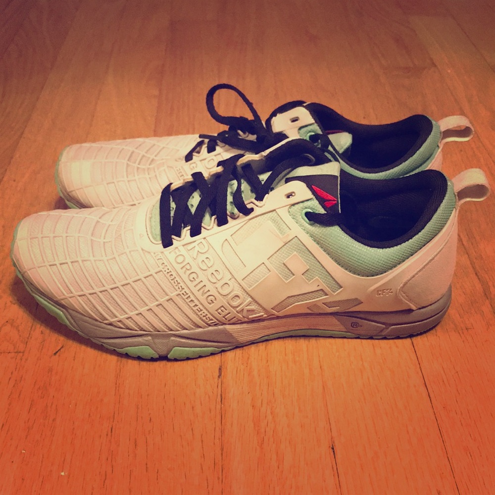 White and mint Reebok CrossFit sneakers.